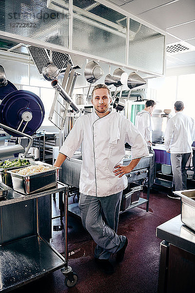 Portrait of confident male chef standing in commercial kitchen