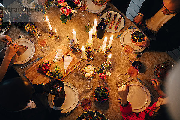 Directly above shot of friends enjoying food at dinner party