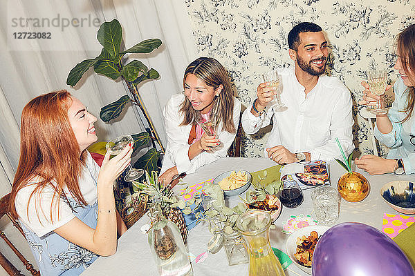 High angle view of young multi-ethnic friends enjoying dinner party at home