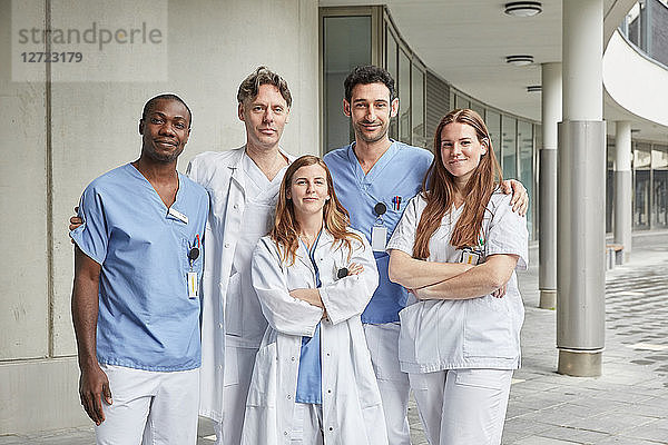 Portrait of confident multi-ethnic healthcare workers standing at hospital