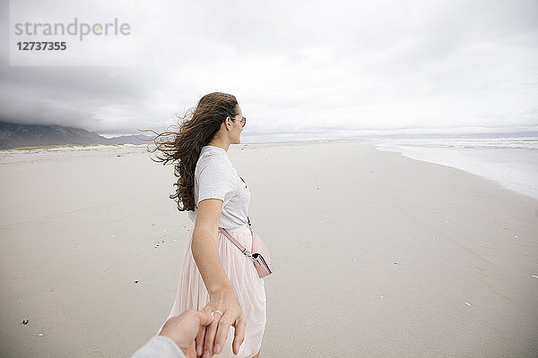 South Africa  Western Cape  Hermanus  woman holding hand on the beach