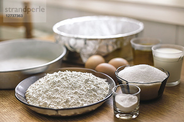 Ingredients for a cake  wheat flower  sugar  milk and eggs on pastry board