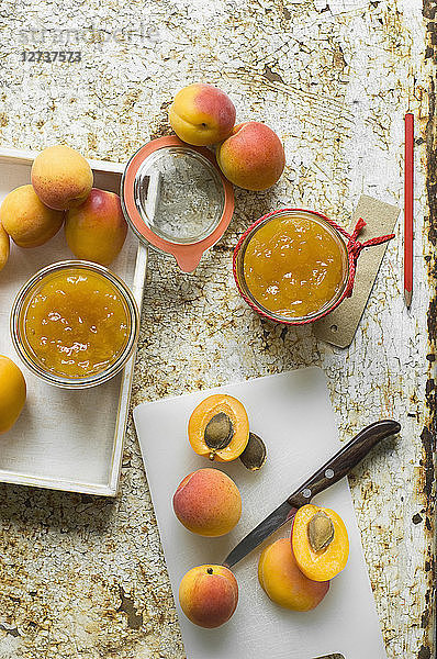 Two glasses of homemade apricot jam and apricots
