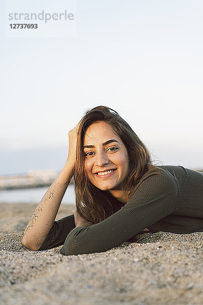 Beautiful woman relaxing on the beach at sunset  portrait
