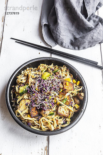 Mie noodles with tofu  zucchini  maize and red sprouts