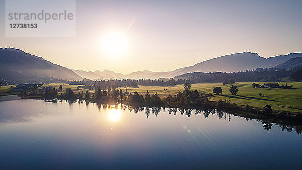 Austria  Tyrol  Kaiserwinkl  Aerial view of lake Walchsee at sunrise