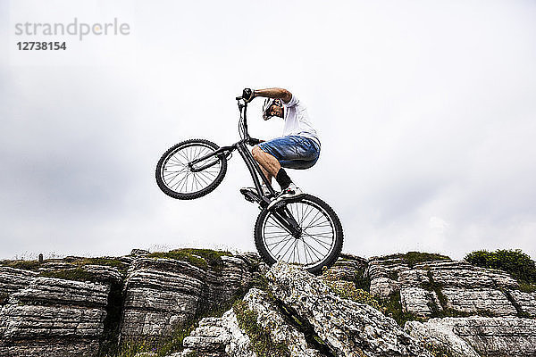 Acrobatic biker on trial bike