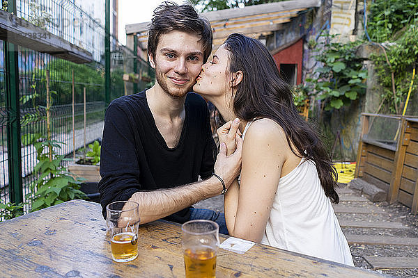 Portrait of young couple at an outdoor bar