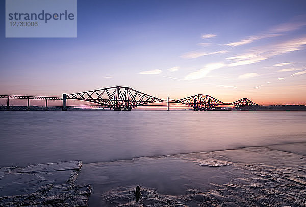 UK  Scotland  Fife  Edinburgh  Firth of Forth estuary  Forth Bridge  Forth Road Bridge and Queensferry Crossing in the background at sunset