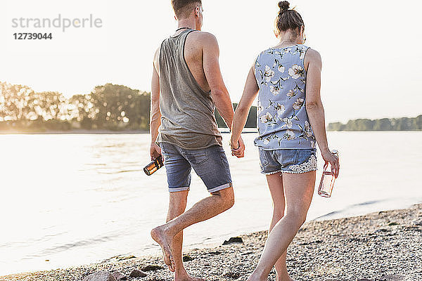 Young couple walking at the riverbank