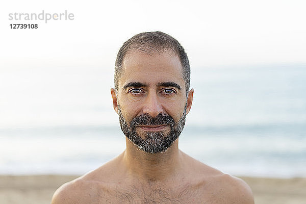 Portrait of happy man on a beach in the evening