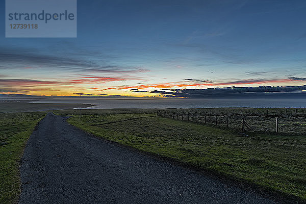 UK  Scotland  Caithness  Duncansby Head  rural road at sunset