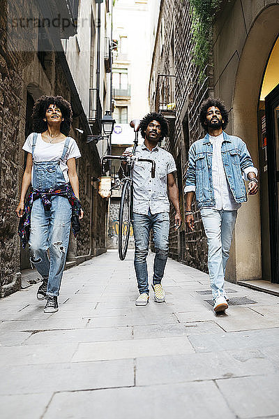 Spain  Barcelona  three friends walking in the city