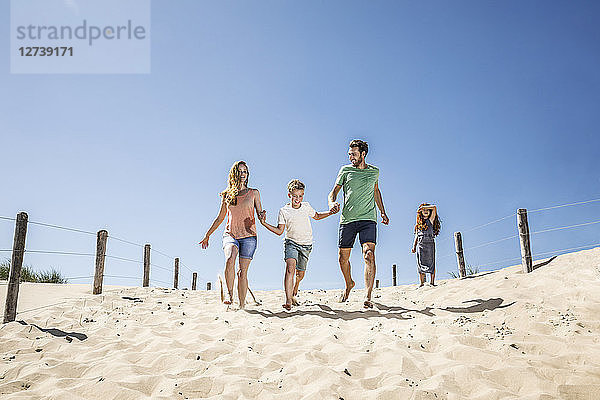 Netherlands  Zandvoort  happy family running on the beach