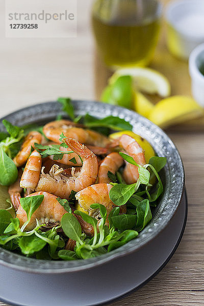 Shrimps with lamb's lettuce on plate