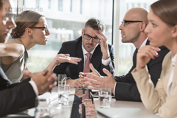 Five business people having an argument