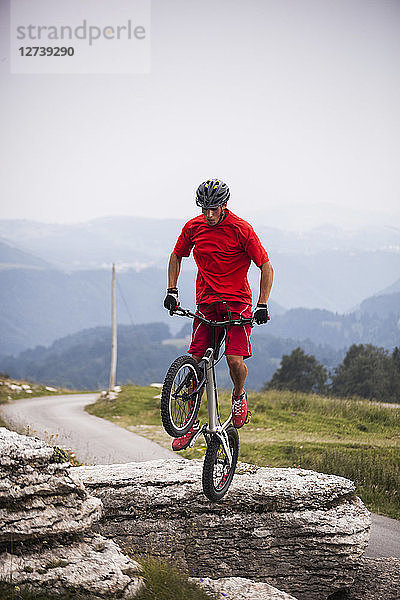 Acrobatic biker on trial bike