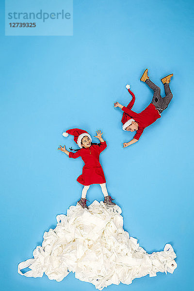 Children playing on a pile of snow  having fun