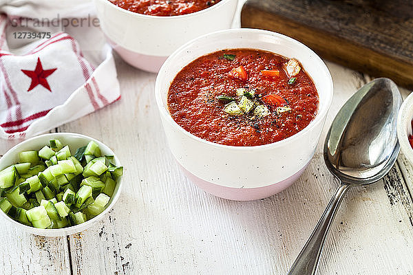 Bowl of Gazpacho with cucumber and bell pepper topping
