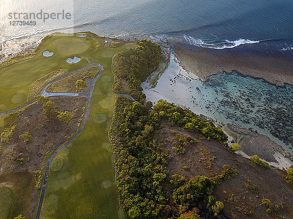 Indonesia  Bali  Aerial view of golf course with bunker and green at coast