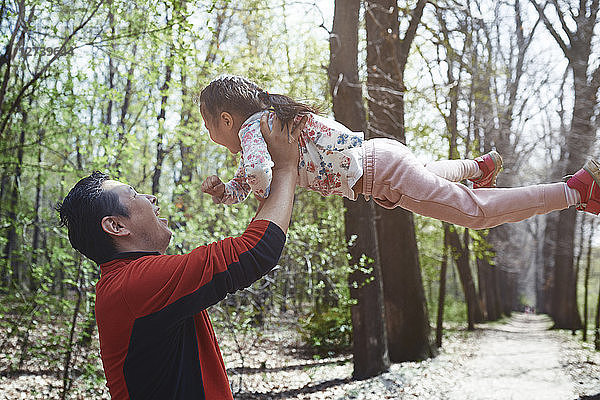 Father and daughter having fun in a park