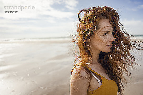 Portrait of a redheaded woman on the beach