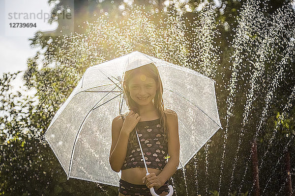 Portrait of smiling girl with umbrella