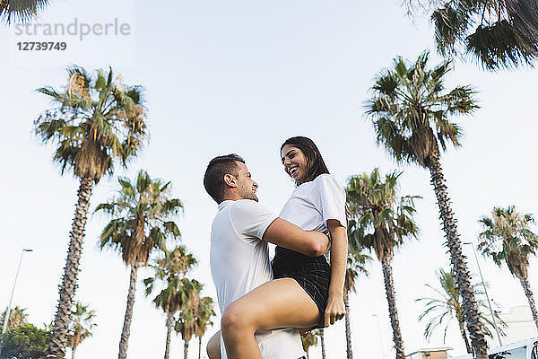 Young couple embracing in park