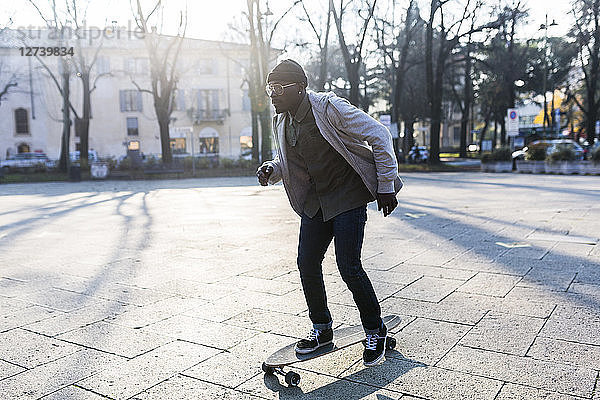 Young man skateboarding on an urban squarre