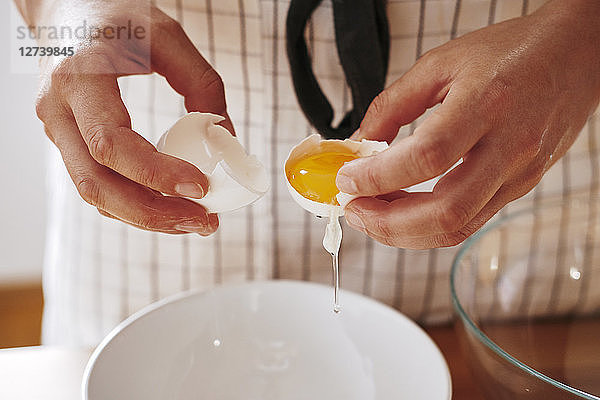 Woman's hands separating egg  close-up