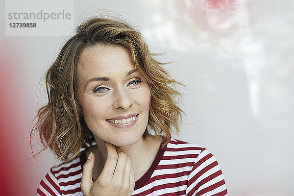 Portrait of smiling woman wearing red-white striped t-shirt