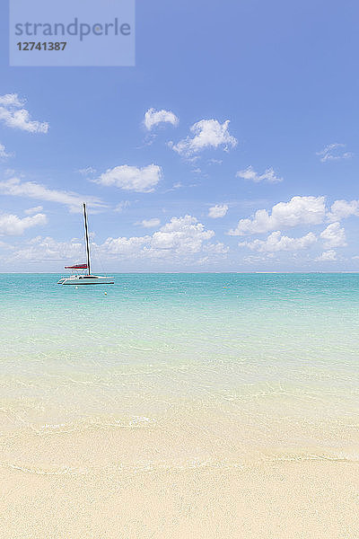 Mauritius  Grand Port District  Pointe d'Esny  sailing boat in turquoise water  blue sky and clouds