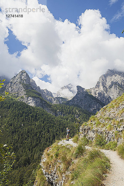 Italy  Trentino  Brenta Dolomites  Parco Naturale Adamello Brenta  woman enjoying mountain scenery on trail along Croz dell' Altissimo