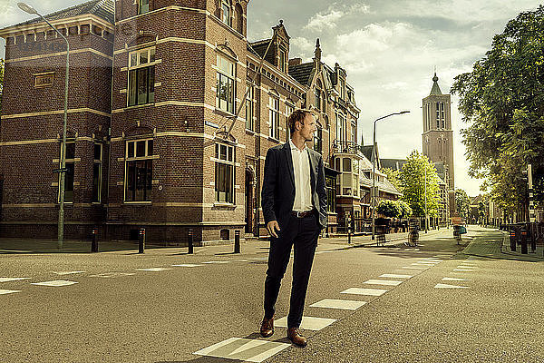 Netherlands  Venlo  businessman walking on a street
