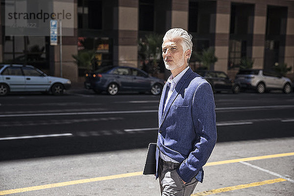 Serene businessman walking in the street