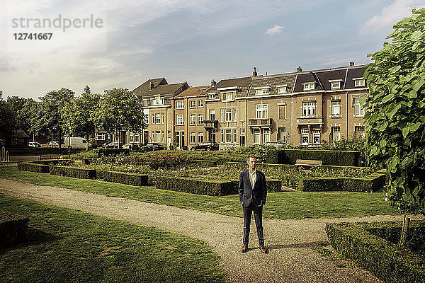 Netherlands  Venlo  businessman standing in city park