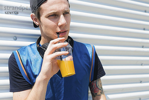 Tattooed young man with soft drink