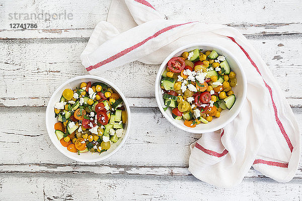 Bowl of salad with chick peas roasted with curcuma  feta  cucumber  tomatoes and parsley