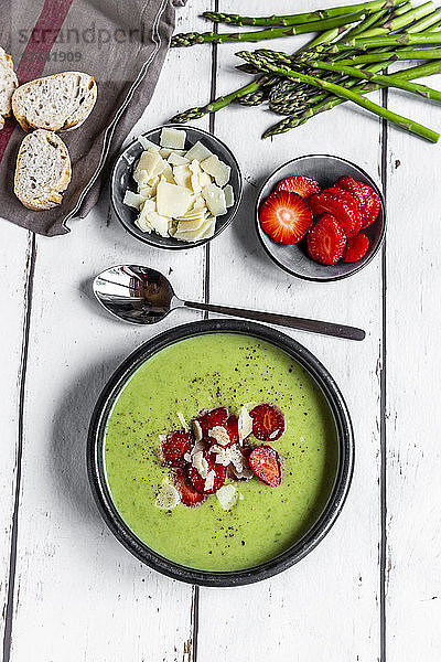 Green asparagus cream soup with strawberry  parmesan and baguette