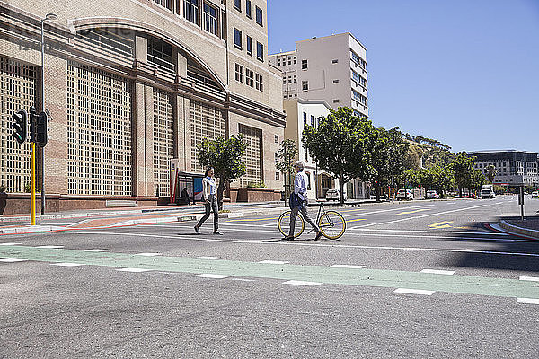 Two people crossing a street
