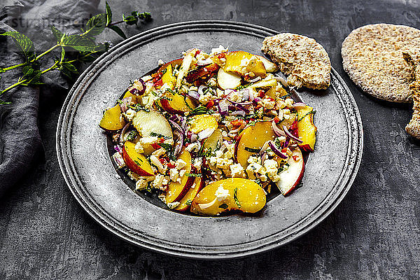 Salad with peaches  feta and mint served with pita bread