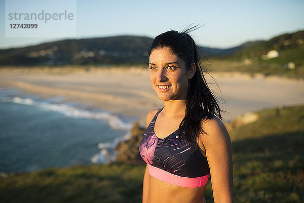 Portrait of an athlete woman in the evening  beach in the background