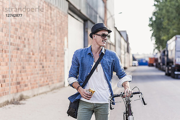Young man with bicycle on the street