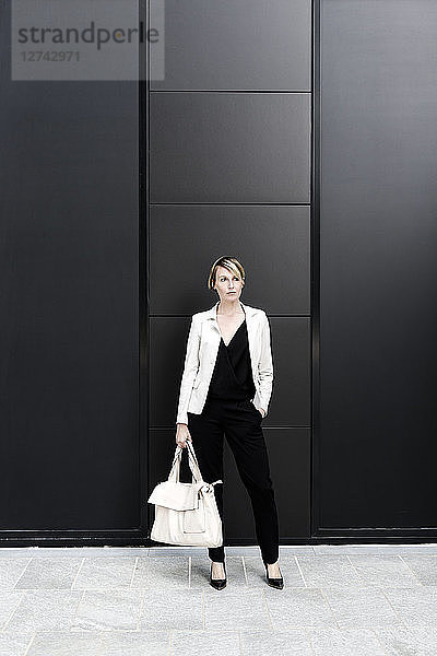Fashionable businesswoman wearing black and white clothes