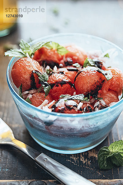 Watermelon salad with eschalot  mint  olive oil and balsamico in bowl