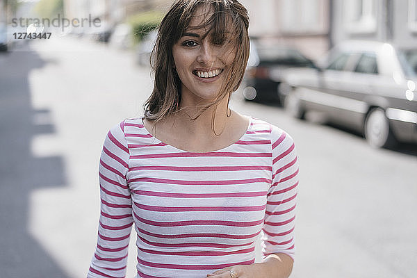 Happy young woman walking in the city