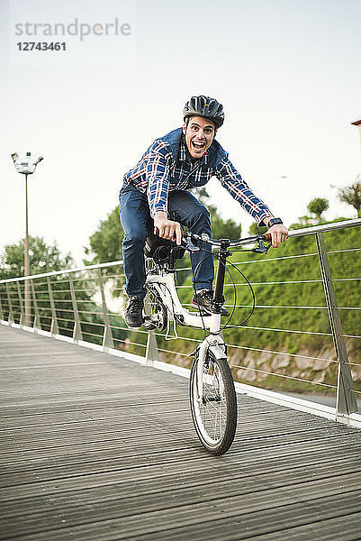 Young man doing tricks with a folding bike