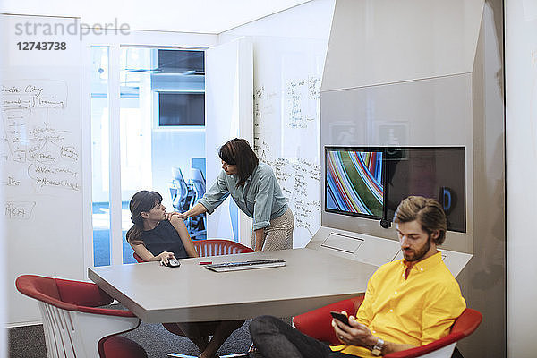 Business people in futuristic office having a meeting