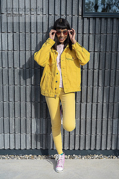 Young woman wearing yellow jeans clothes