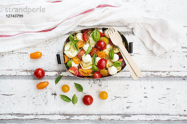 Tortellini salad with tomato  mozzarella and basil in lunch box